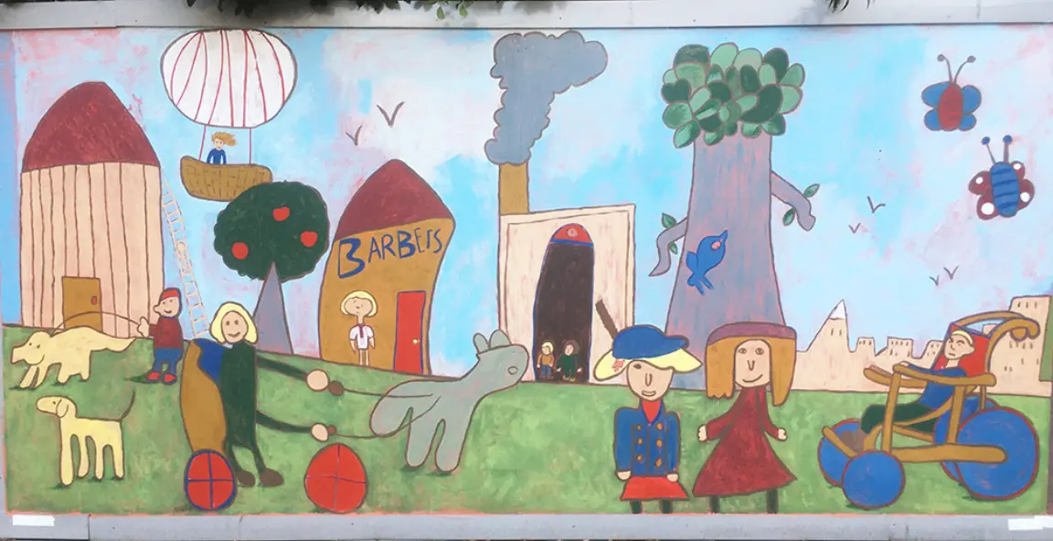 Part of Swindon Heritage Action Zone improvements. Murals on hoardings at the Mechanics' Institue in Swindon. Schools' art workshop with Robert le Kyng Primary School Swindon on the theme 'Living in the Railway Village'